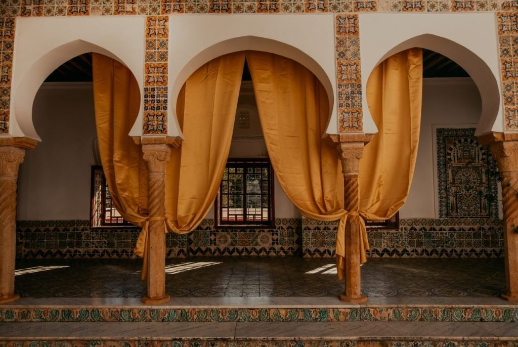 Moroccan palace interior with arches and gold curtains, Fes Luxury Tours