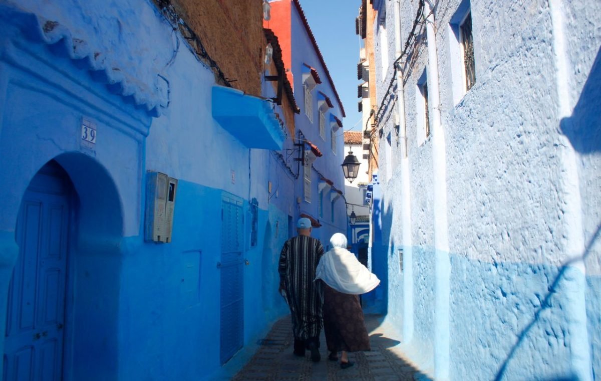 Couple walking through the blue alleys of Chefchaouen