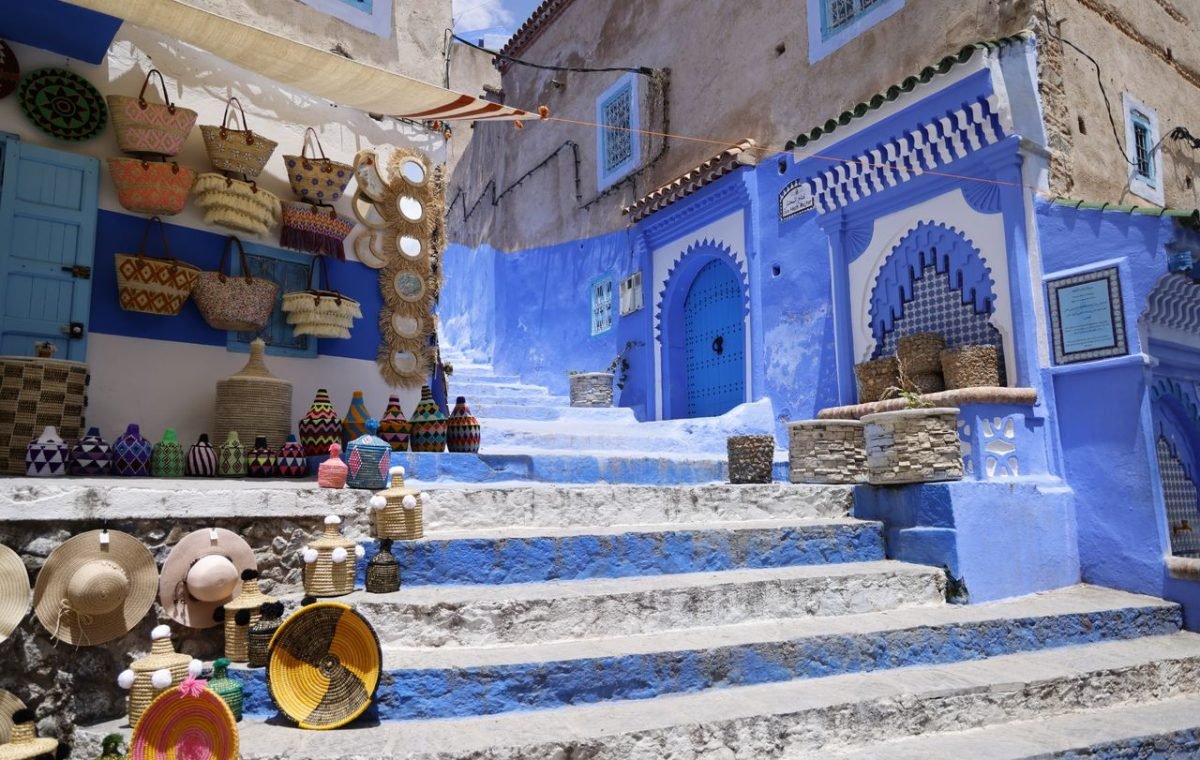Shops and goods along a sunny lane in a Moroccan souk