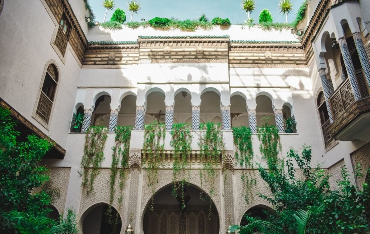 Arched courtyard with climbing plants in Fes